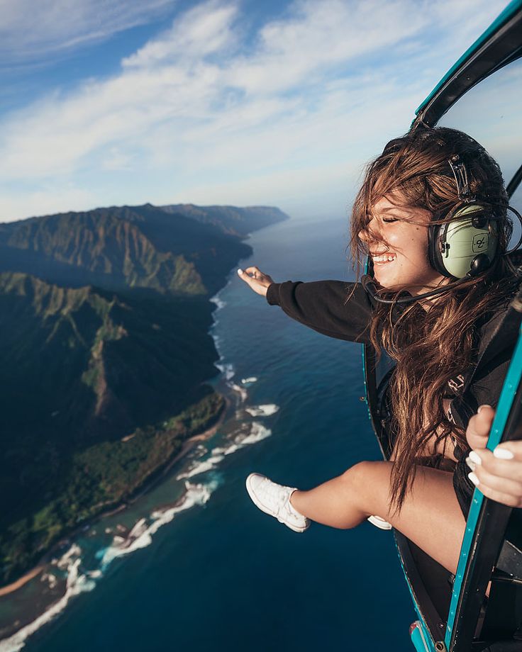 a woman is flying in an airplane over the ocean