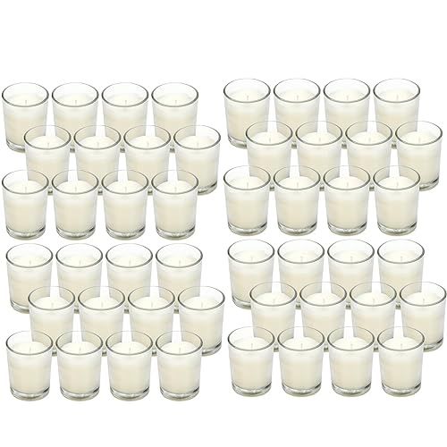 a large group of glasses filled with white liquid next to each other on a white surface