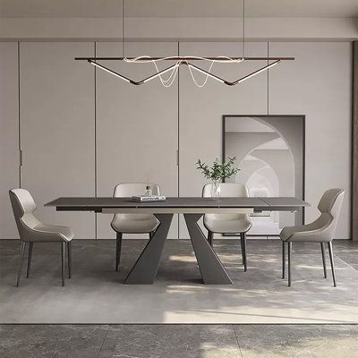 a modern dining table with white chairs and a chandelier hanging from the ceiling