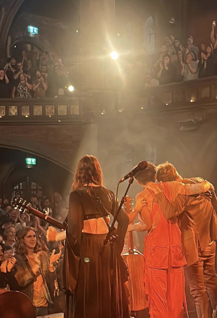 two people standing on stage in front of an audience