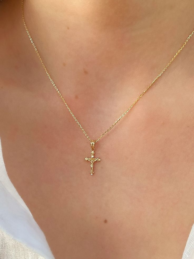 This unique dainty Crucifix Cross Necklace features a small gold cross with a high polish finish that sits on a delicate 14K Yellow Gold chain. It's perfect for layering with your favorites or styled solo for a classic look. Necklace Length: 16 Inches *with a 2-inch extension Pendant Length: 1.6 cm * Bail: 0.4 cm Pendant Width: 1 cm Chain Type: Flat Cable Clasp: Lobster Metal: 14K Yellow Gold (stamped) Small Cross Necklace Simple, Gold Cross Jewelry, Gold Jewelry Cross, Good Cross Necklace, Small Gold Cross Necklace, Simple Cross Necklace Gold, Cross Necklace Aesthetic, Cross Gold Necklace, Gold Cross Necklace For Women