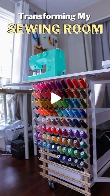 a sewing machine sitting on top of a wooden table next to a shelf filled with colorful thread