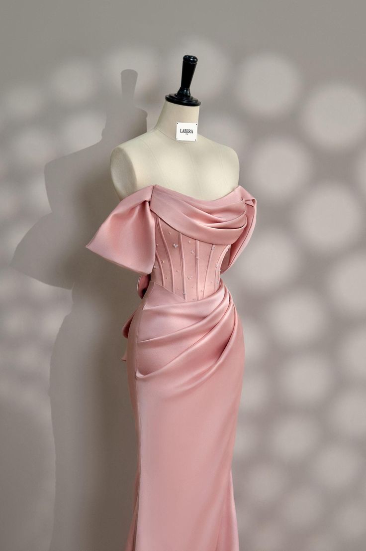 The pink satin party dress, featuring a corset top, is a breathtaking option for any special occasion, from parties to post-wedding celebrations and glamorous events. The silky satin fabric drapes elegantly, giving the dress a luxurious sheen that catches the light beautifully. The corset bodice not only provides structure but also highlights the waist, creating a flattering, hourglass silhouette. The soft pink hue adds a touch of romance and femininity, making it perfect for a chic and sophisti Pink Event Dress, Pink Corset Bridesmaid Dress, Elegant Evening Dress With Corset Back For Banquet, Satin Prom Dress For Party Season, Satin Prom Evening Dress For Party Season, Satin Fitted Evening Dress For Prom, Satin Evening Dress For Prom Party Season, Satin Evening Dress For Prom And Party Season, Prom Satin Evening Dress For Party Season