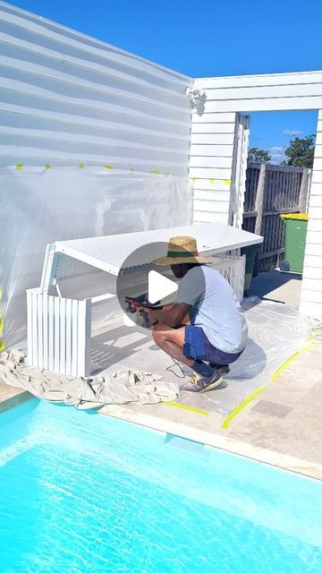 a man painting the side of a swimming pool