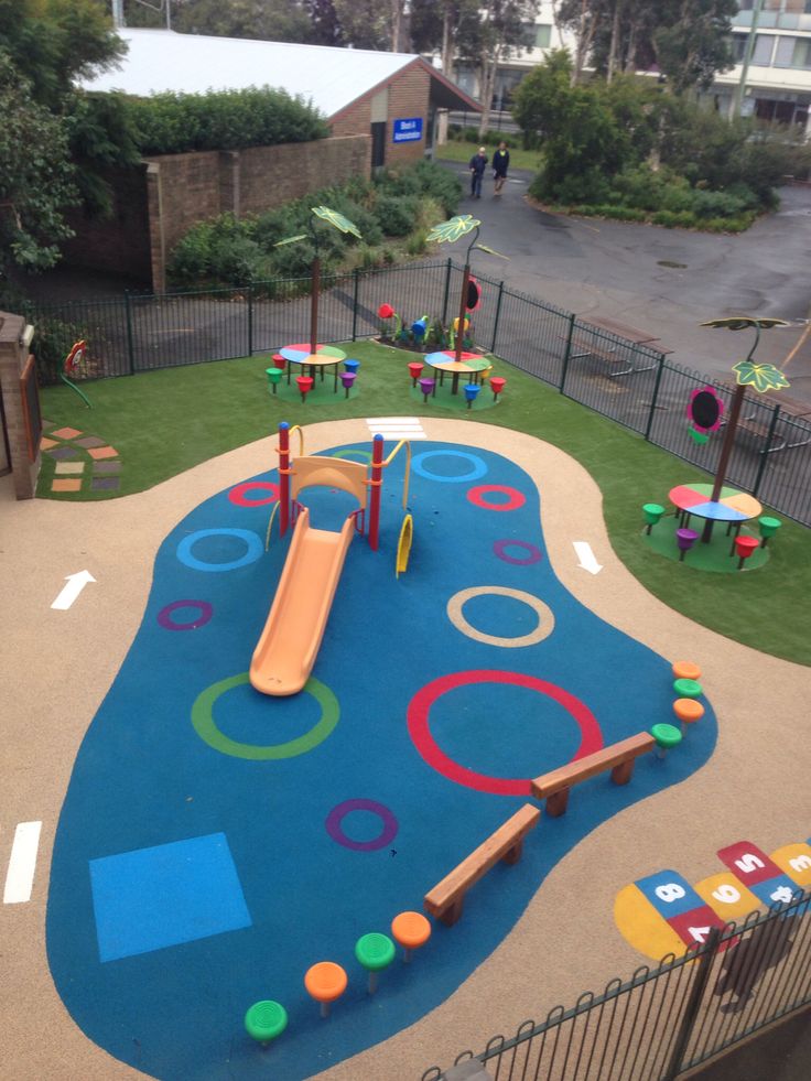 an outdoor play area with colorful playground equipment