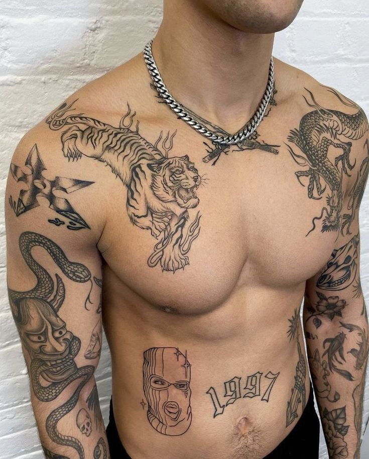 a man with many tattoos on his chest