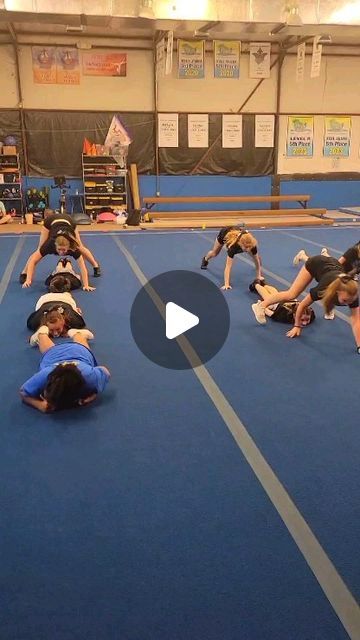 a group of people standing on top of a blue floor