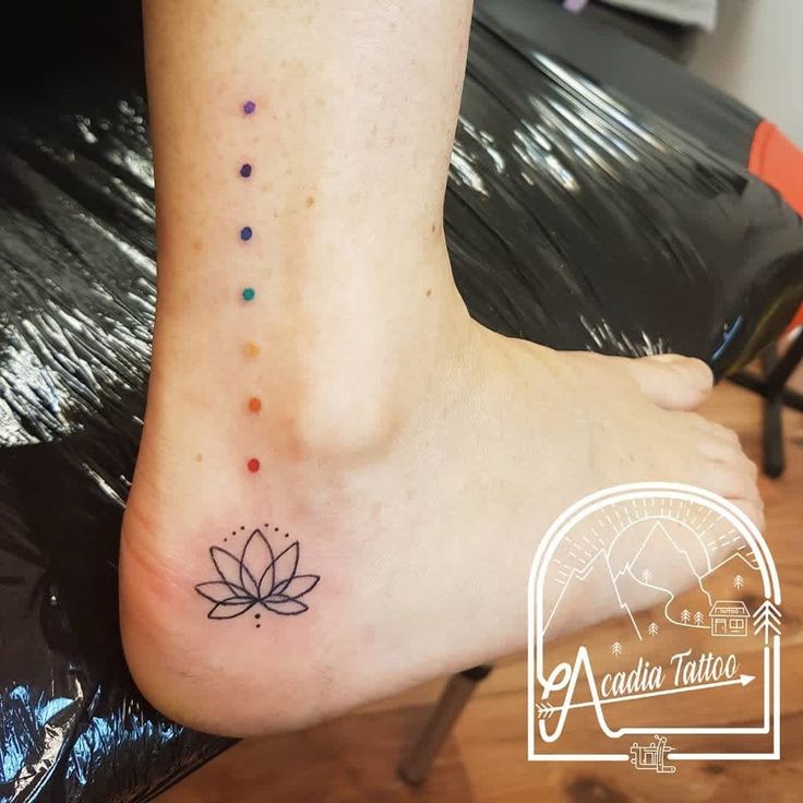 a woman's foot with a small tattoo on it