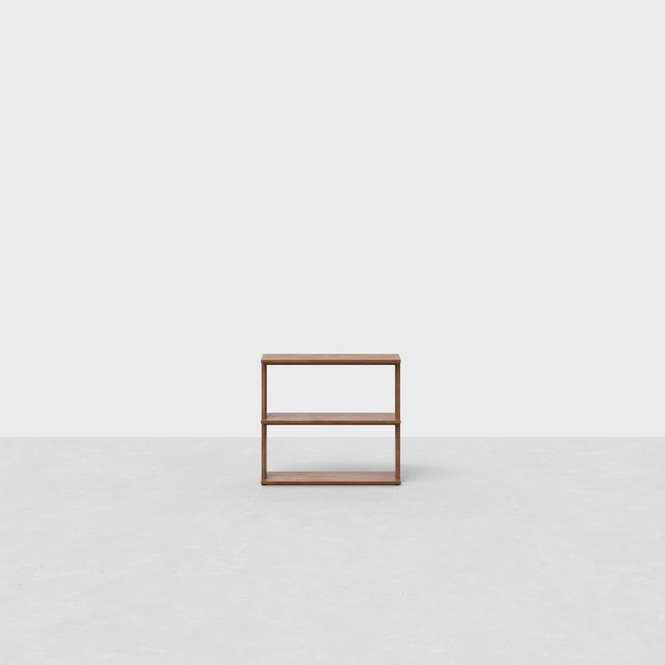 a small wooden shelf sitting on top of a white floor