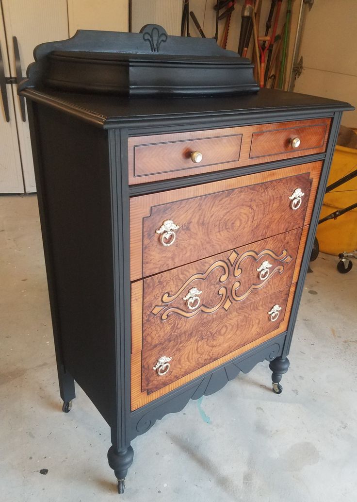 a black and brown dresser sitting inside of a garage