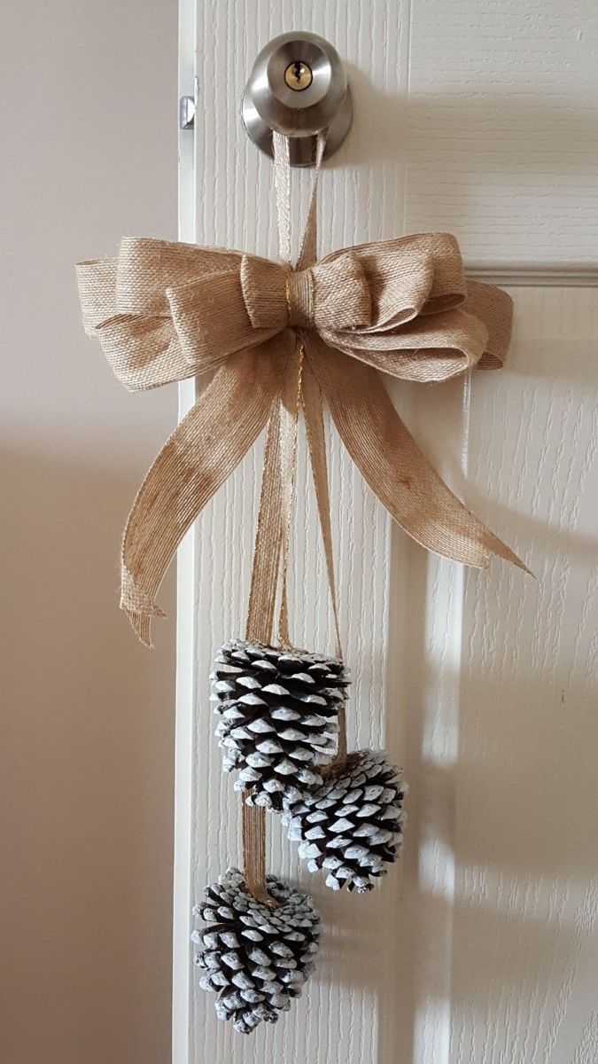 pine cones are hung on the door handle and tied with burlock to give them a festive touch