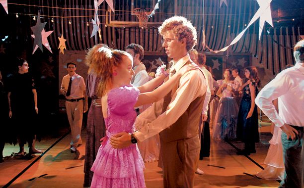 a man and woman dancing on a dance floor in front of a group of people