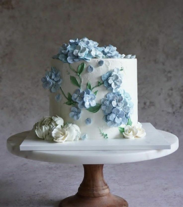 a white cake with blue and white flowers on it