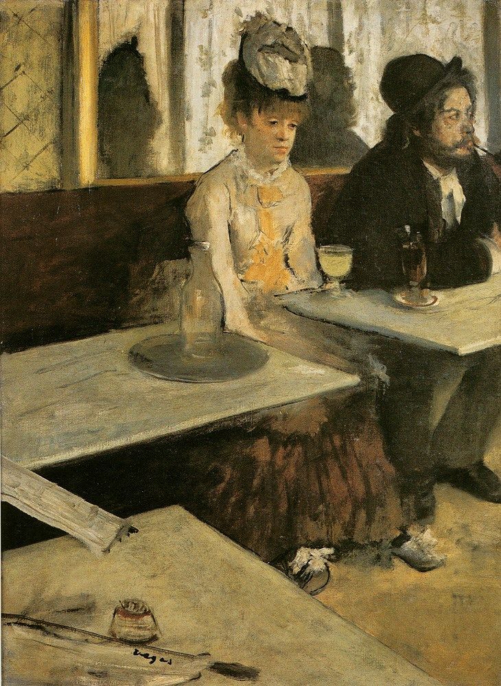 two people sitting at a table with wine glasses