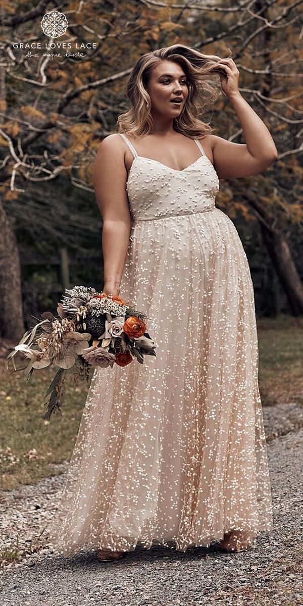 a woman in a white dress is holding her hair