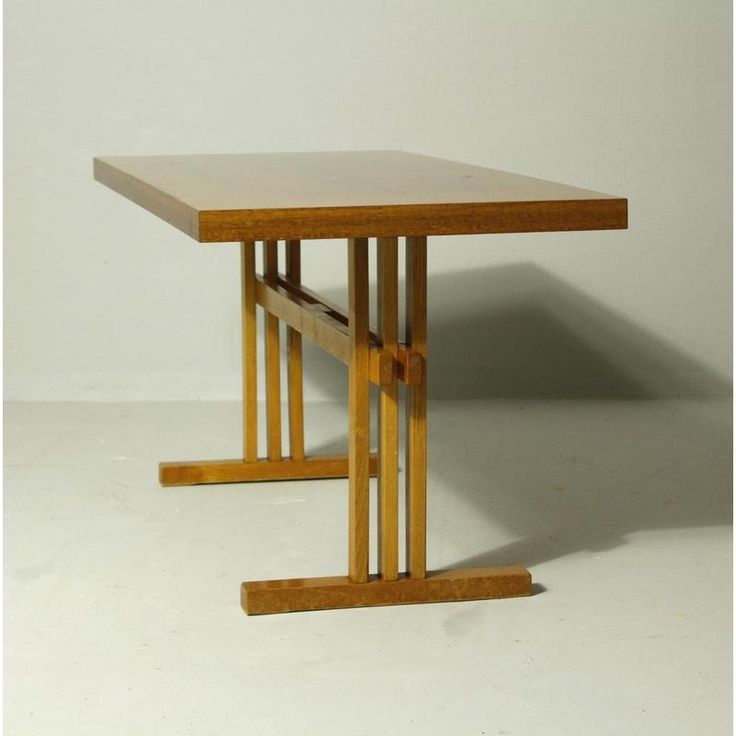 a wooden table sitting on top of a white floor