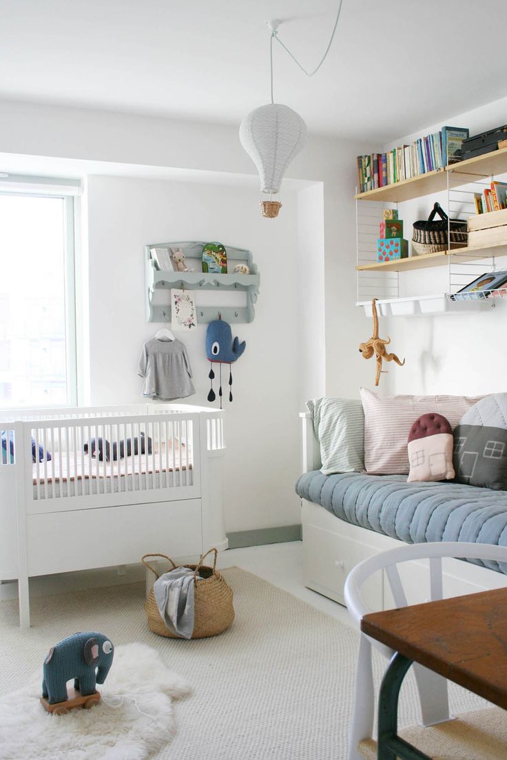 a baby's room with a crib and bookshelf