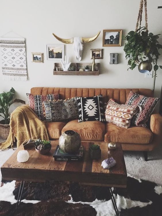 a living room filled with lots of furniture and pictures on the wall above it's coffee table