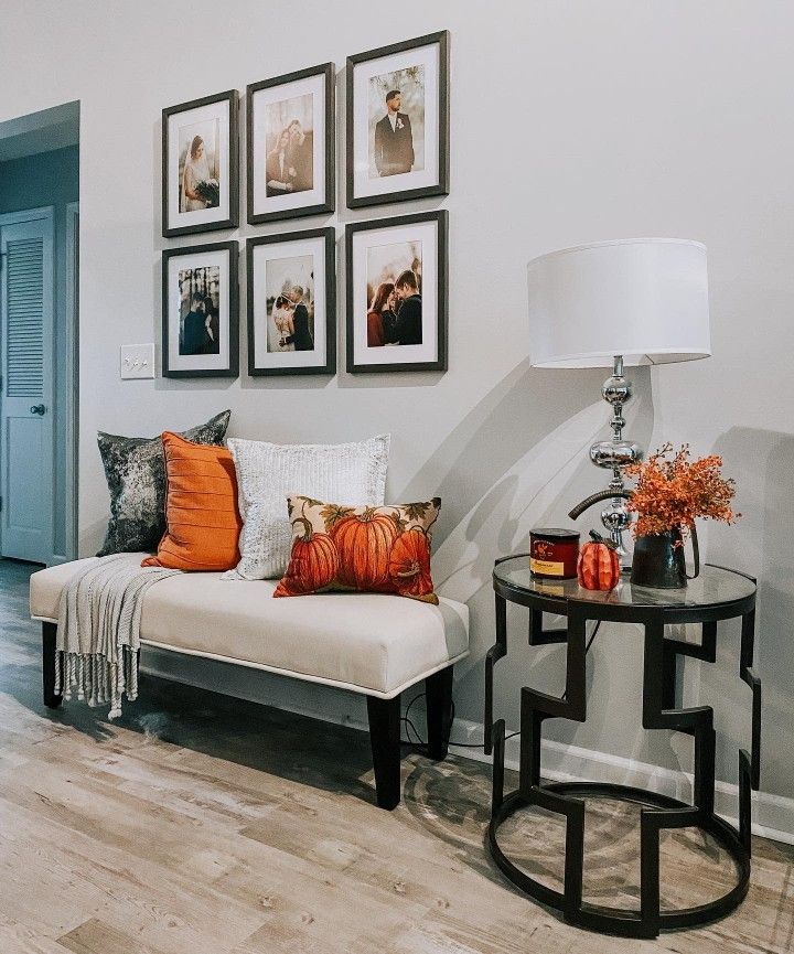 a living room filled with furniture and pictures on the wall above it's coffee table