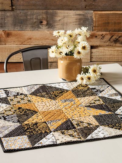 a table topped with a vase filled with white flowers and a star shaped placemat