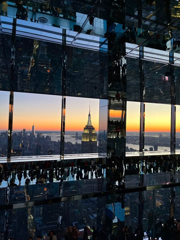 the empire building seen from top of the rock in new york city, ny at sunset