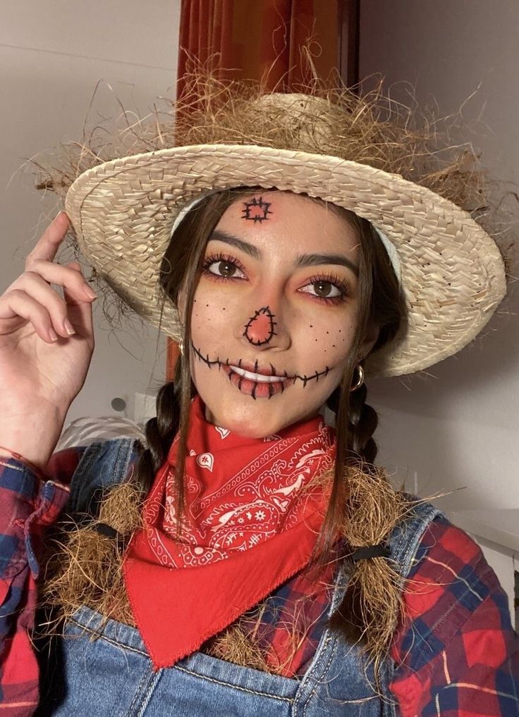 a woman wearing a straw hat with fake teeth and nose paint on her face,