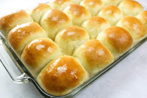 a baking pan filled with rolls on top of a counter