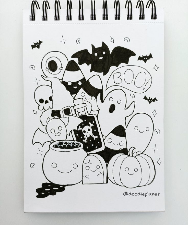 a spiral notebook with halloween doodles on it