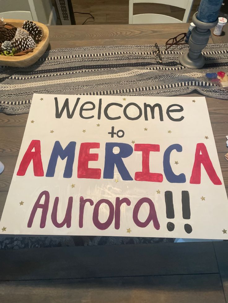 a welcome to america sign sitting on top of a table