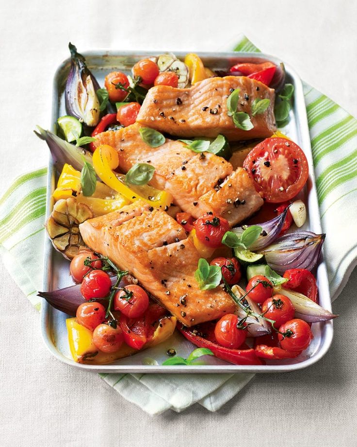 salmon and vegetables in a dish on a table