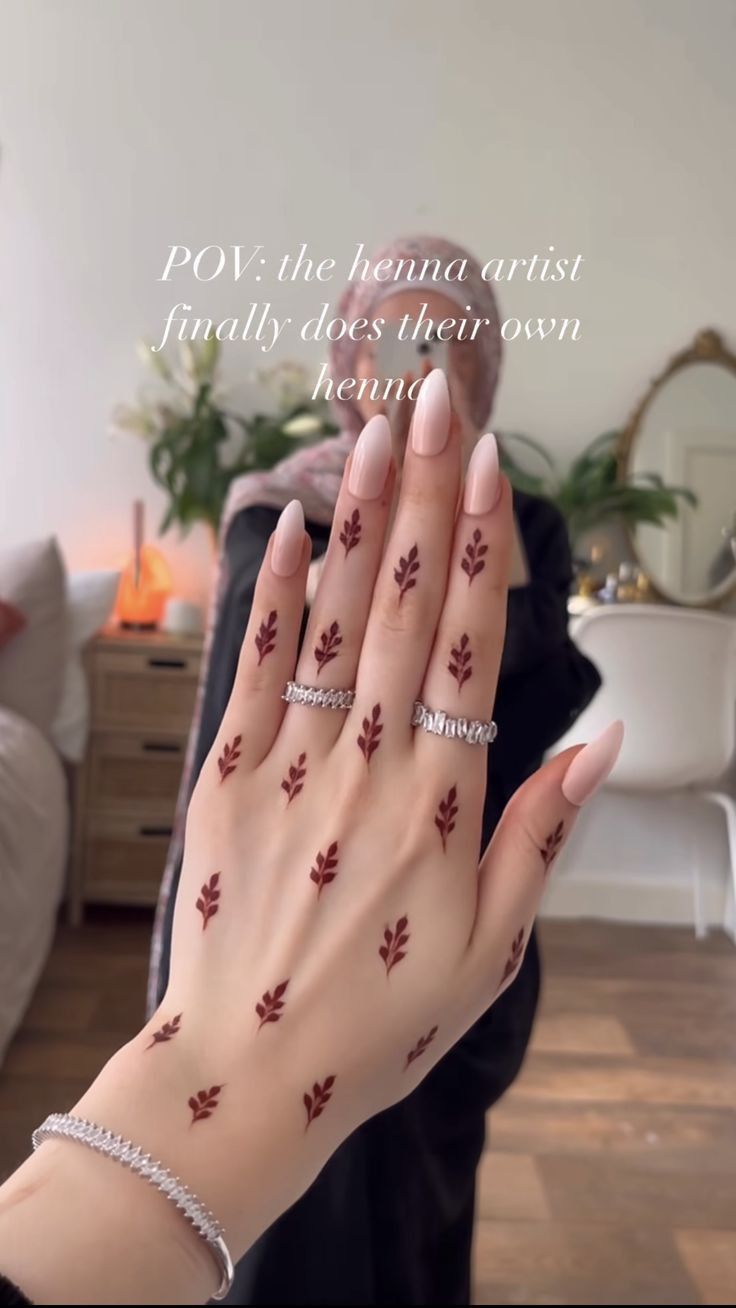 a woman's hand with red leaves painted on it and the words pov in front of her