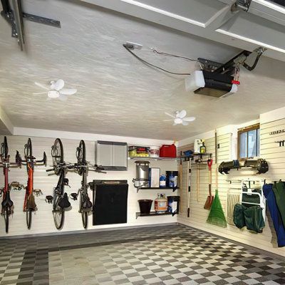 a garage with checkered floor and lots of bikes hanging on the wall