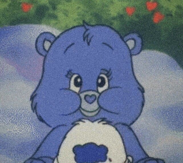 a blue teddy bear holding a white ball