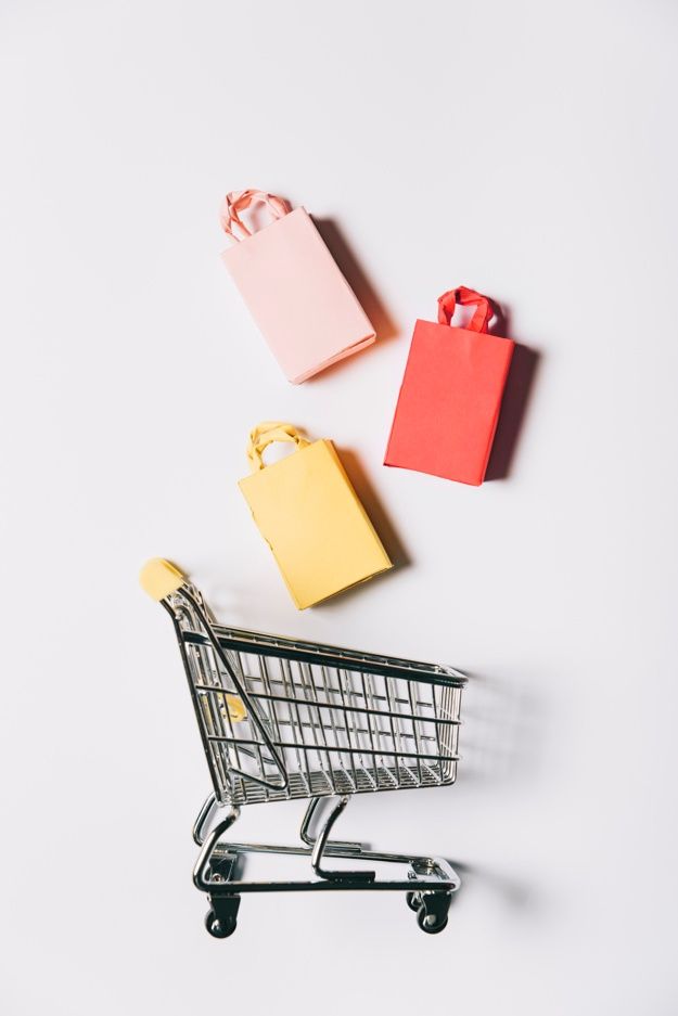 an empty shopping cart with two small gift bags