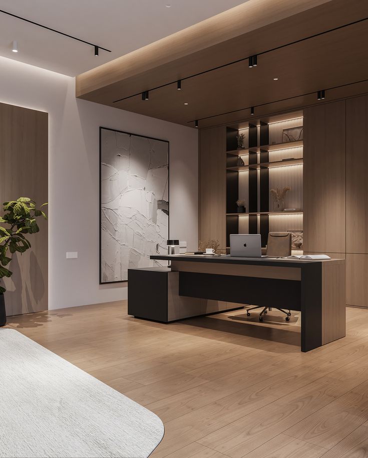 an office with a desk, chair and potted plant in the middle of the room