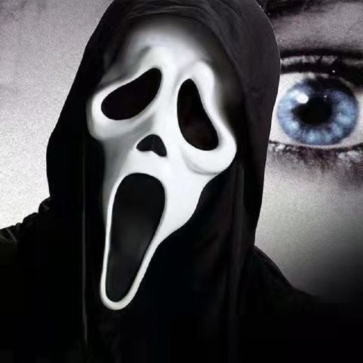 a person wearing a ghost mask with blue eyes