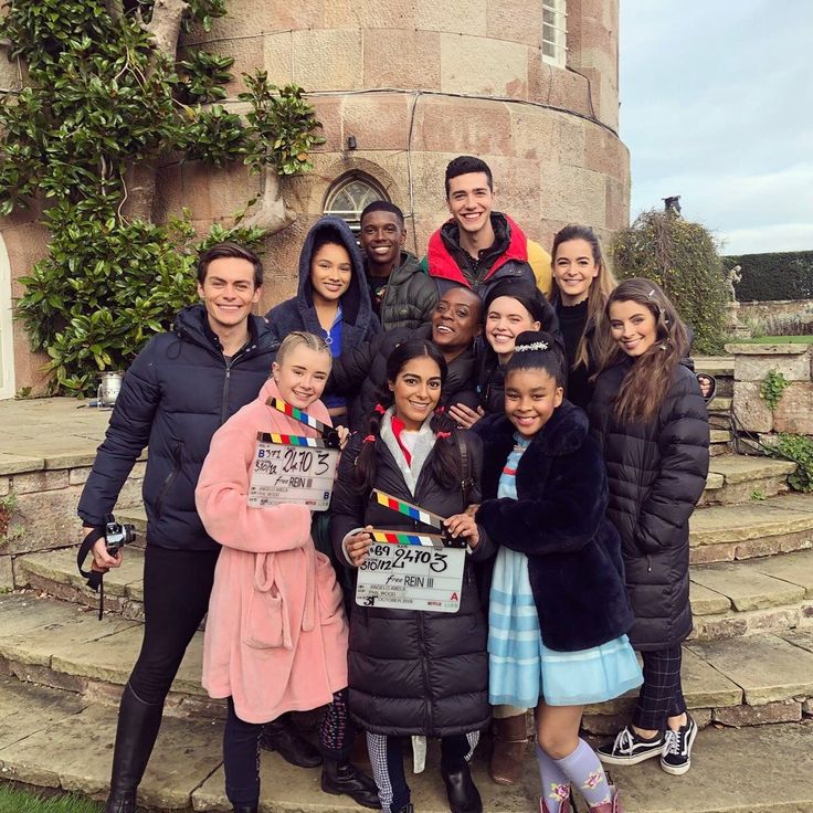 a group of people standing in front of a castle