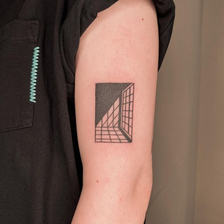 a black and white photo of a person's arm with a geometric tattoo on it