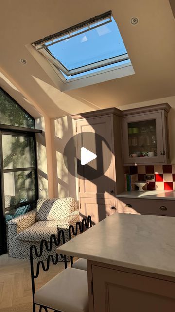 a kitchen with an open skylight above the counter