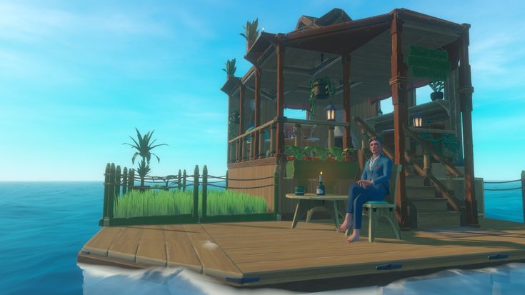 a woman is sitting on a dock in front of a house