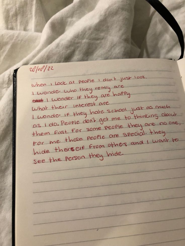 an open notebook with writing on it and someone's handwritten note in red ink