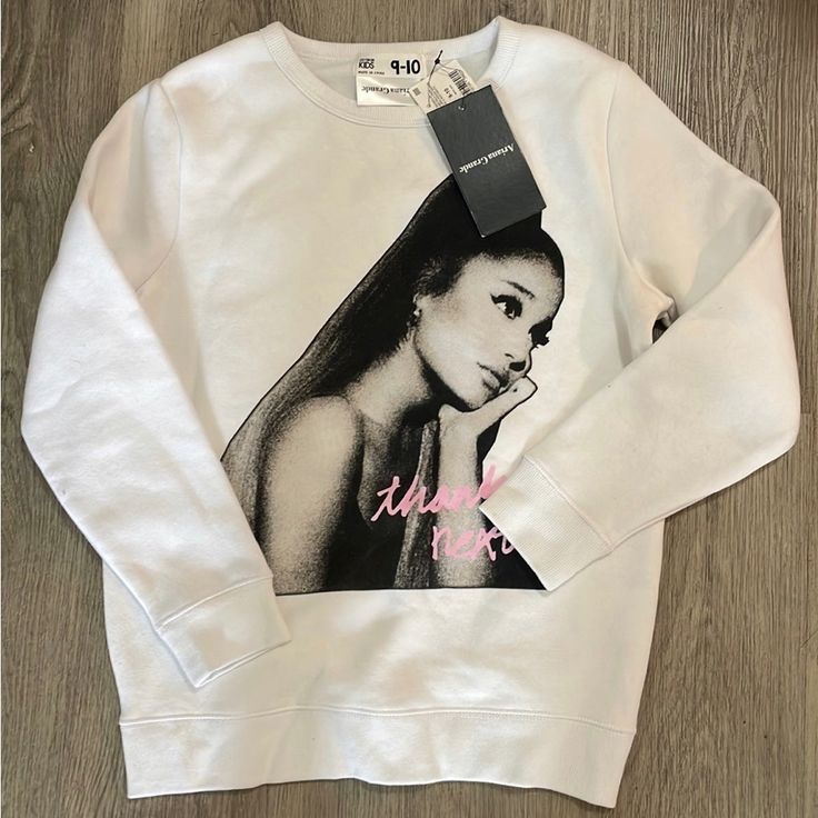 a white sweatshirt with an image of a woman on it