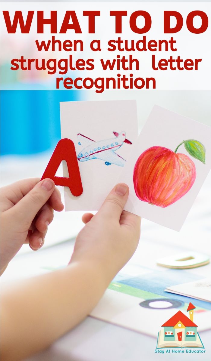 a person holding an apple with the letter a in front of it, and another hand holding