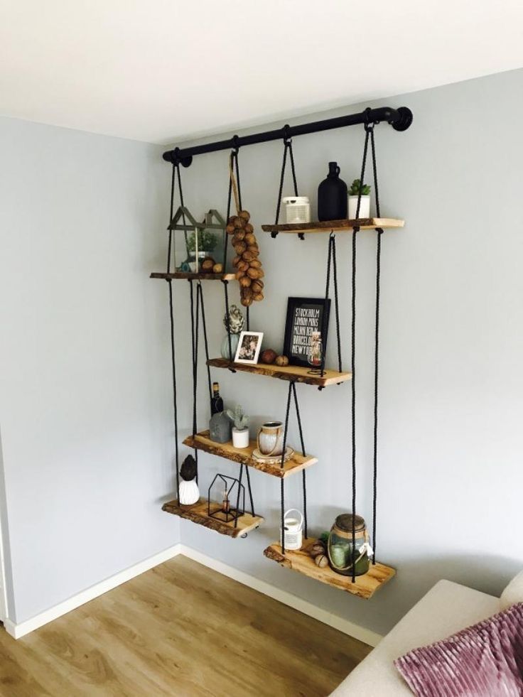 a living room filled with furniture and hanging shelves