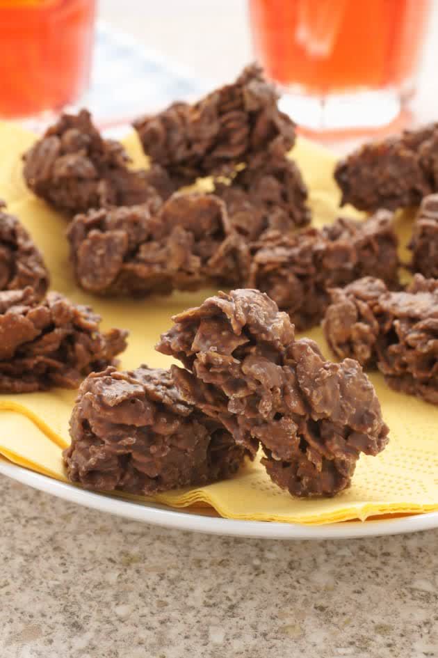 chocolate cookies are arranged on a plate with orange juice in the backgroung