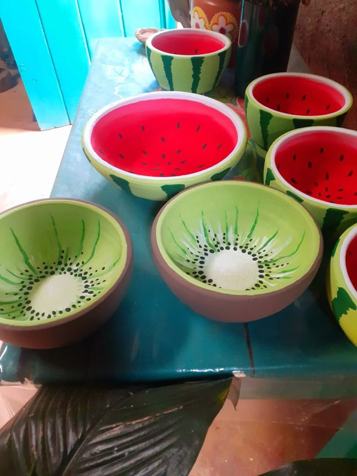 several bowls with different designs on them sitting on a table