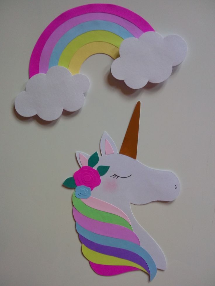 paper cut out of the shape of a unicorn and rainbow