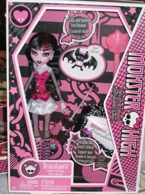 a doll in a pink and black box