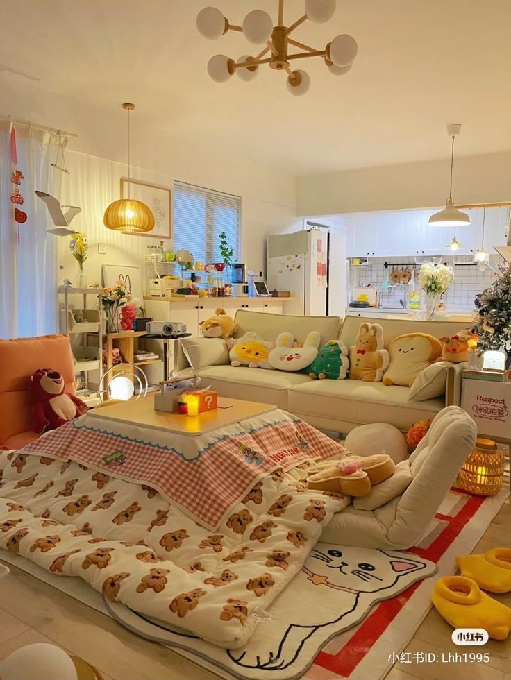 a living room filled with furniture and a teddy bear blanket on the floor in front of a window