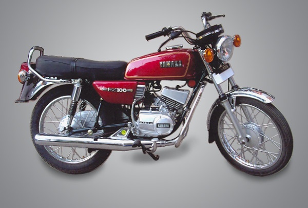 a red motorcycle parked on top of a gray background